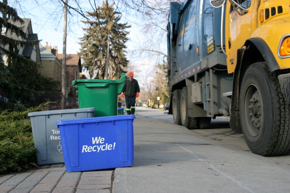 A recycling truck picking up waste.