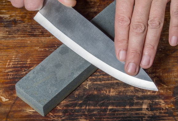Knife being sharpened on a whetstone