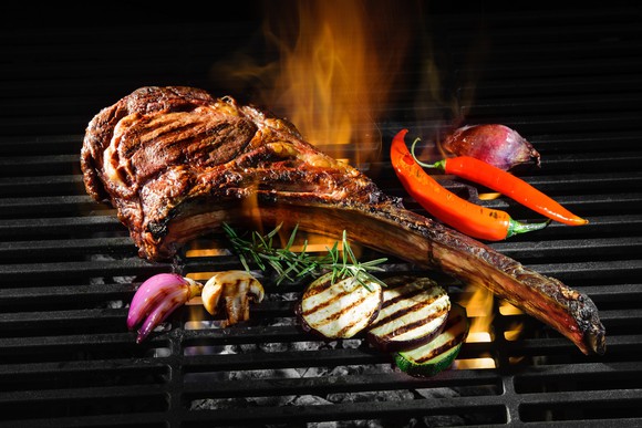A steak and vegetables on a grill