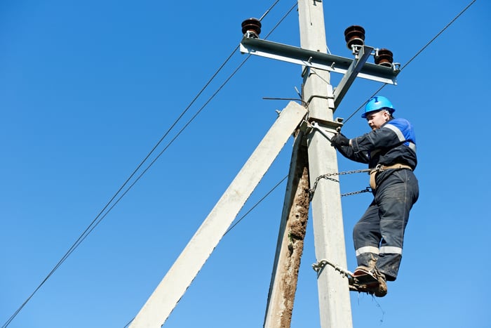 A man working on an overhead power line.