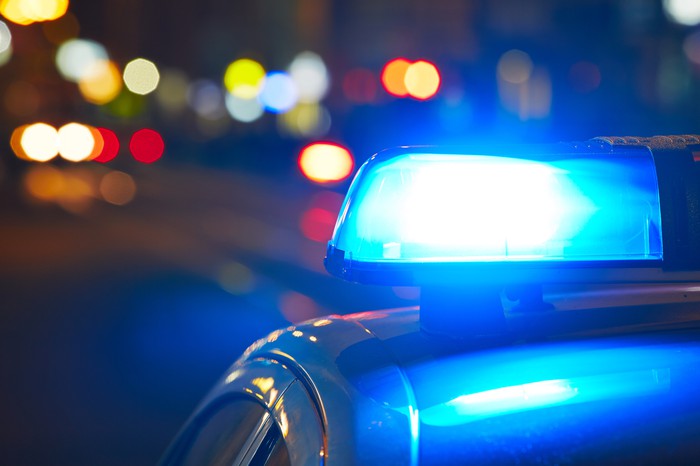 Flashing blue lights on a police car at night