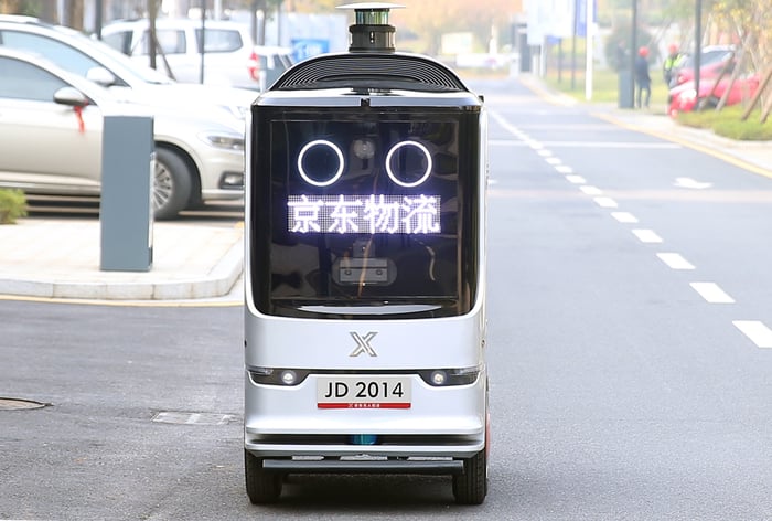 One of JD's autonomous delivery robots is seen on the street.