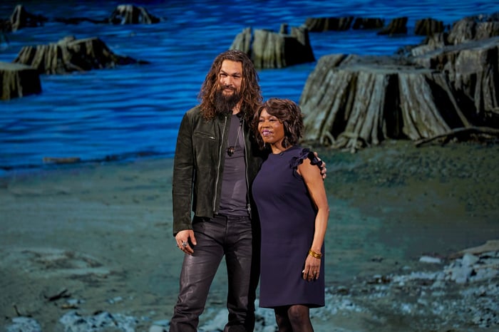 Jason Momoa and Alfre Woodard in front of a scenic backdrop.