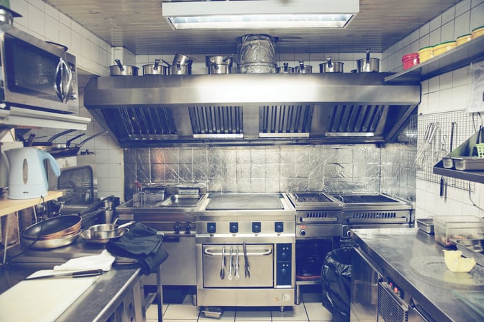 Forlorn looking commercial kitchen with an oven in the center