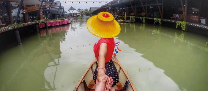 GoPro footage of a woman holding a man's hand on a boat.