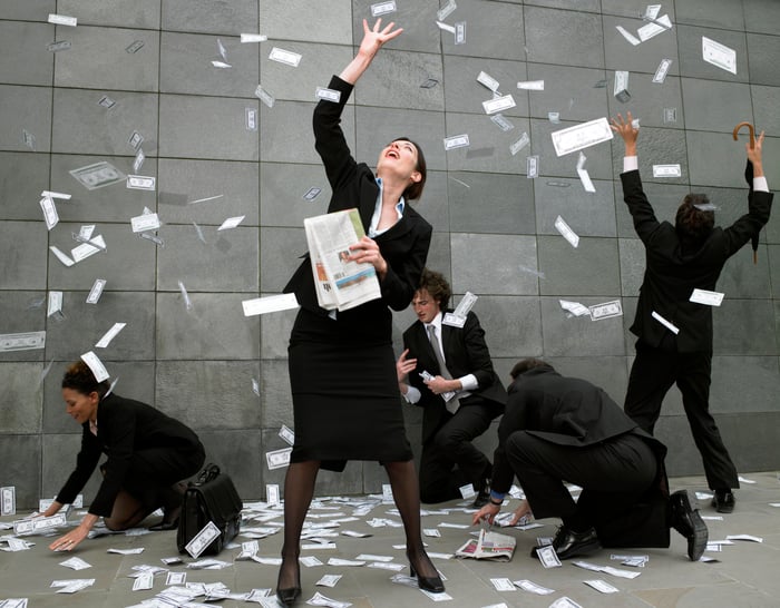 Dollars rain on people in suits
