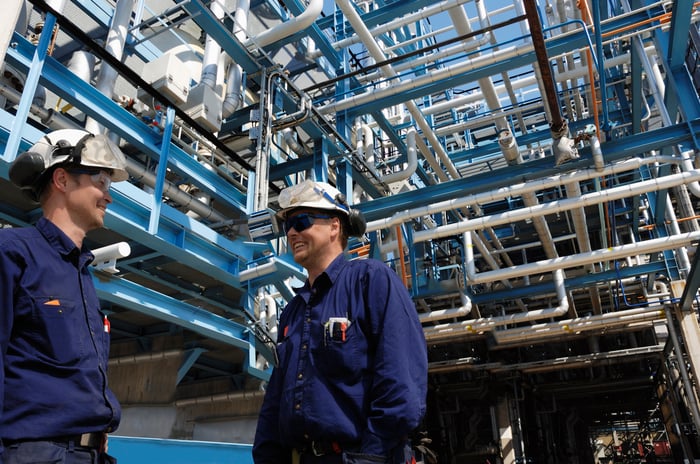 Two men talking at an energy processing plant