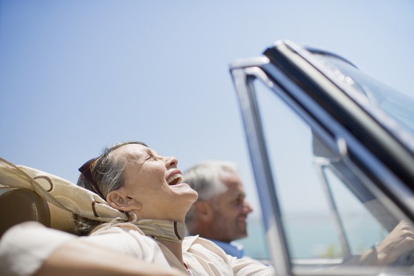Retired man and woman in convertible.