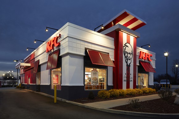 The exterior of a KFC restaurant at night.