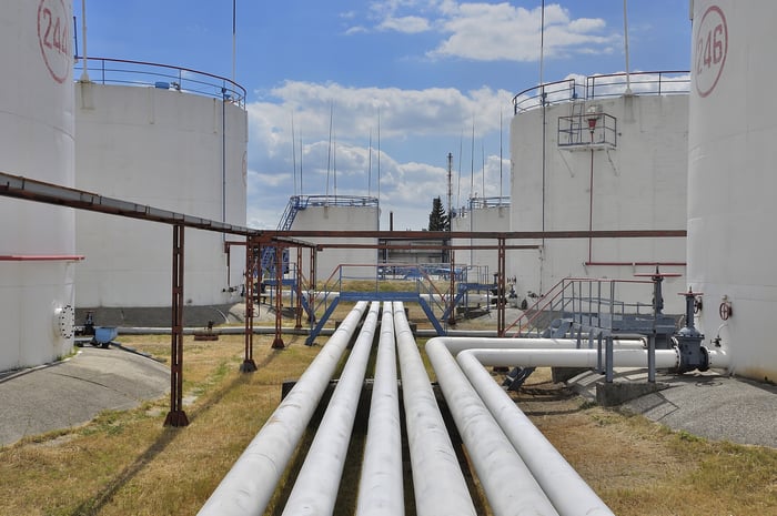 Oil and gas pipeline leading to storage tanks.