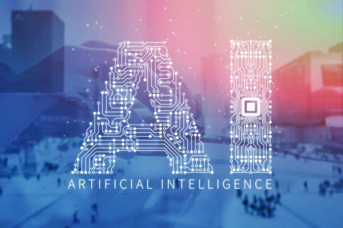 Letters "AI" comprised of electronic circuit board and office buildings in background.