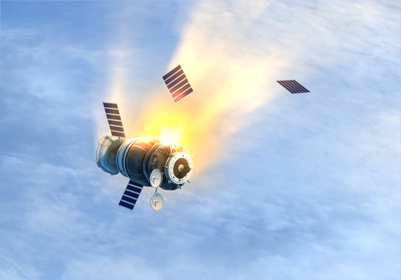 Satellite falling through sky and burning