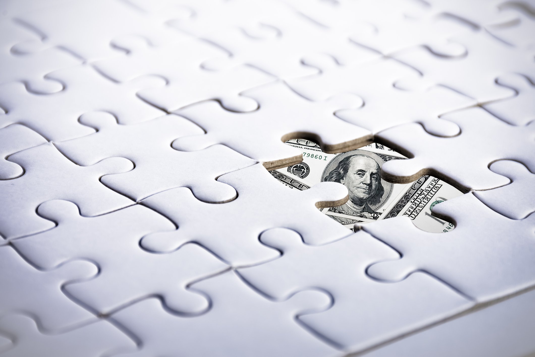A dollar bill hidden beneath a puzzle hidden money