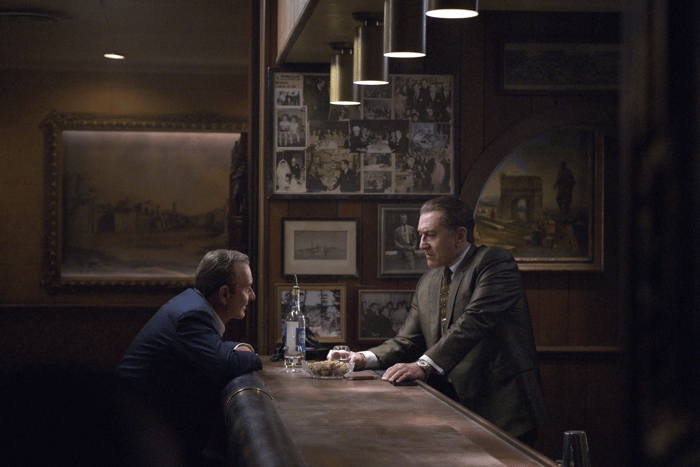 Joe Pesci and Robert De Niro on either side of a bar talking to each other.