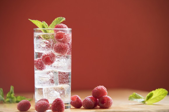 Glass of seltzer with raspberries