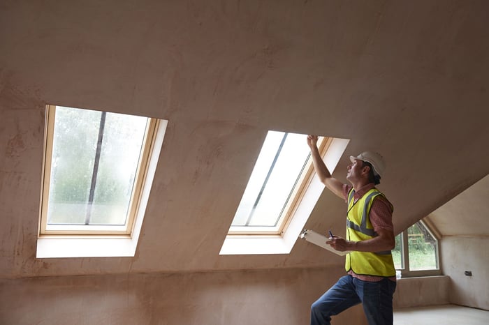 A man in hard hat does construction work.