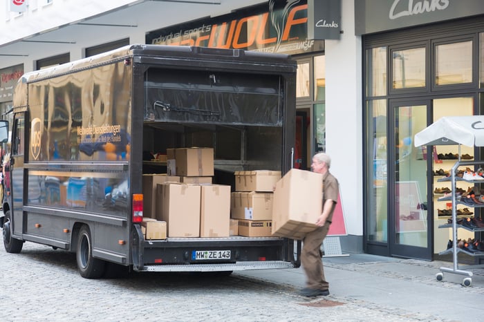 A delivery truck dropping off boxes