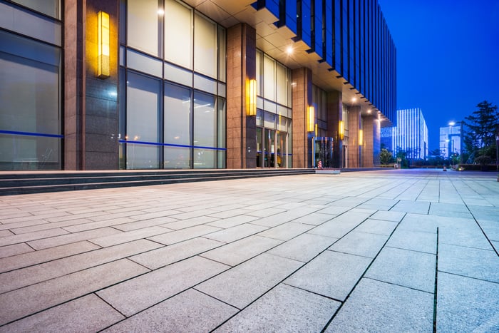 Contemporary exterior lighting on a commercial building at dusk.