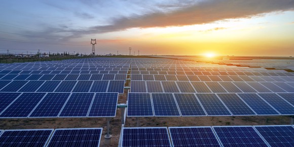 A solar energy facility at sunset.