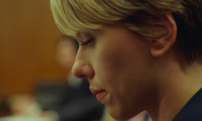 A close-up of Scarlett Johansson with a despondent look on her face.