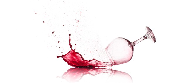 Glass of wine spilling