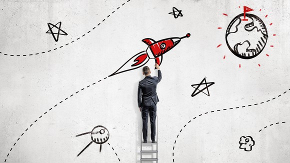 businessman drawing rocket