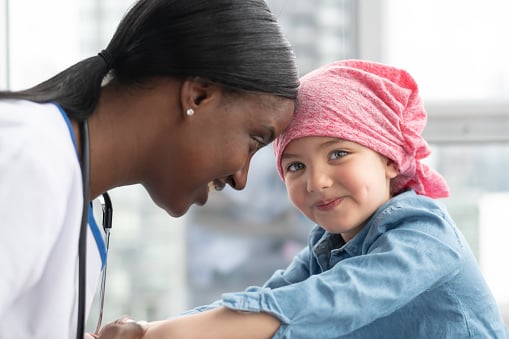 female healthcare provider and child oncology patient