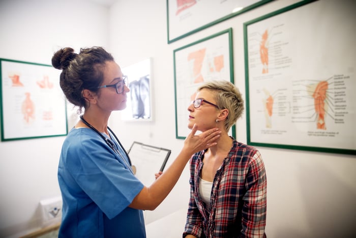 Doctor examining a patient in a walk-in clinic examination room..