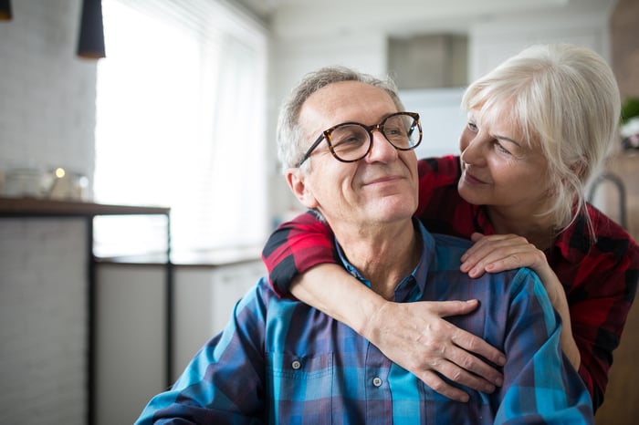 Older couple hugging.