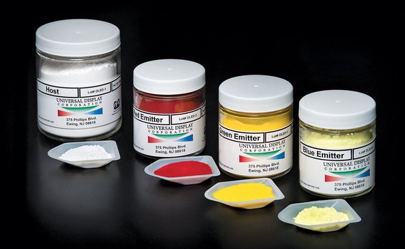 Four jars of Universal Display OLED materials, including one host jar and three emitters.