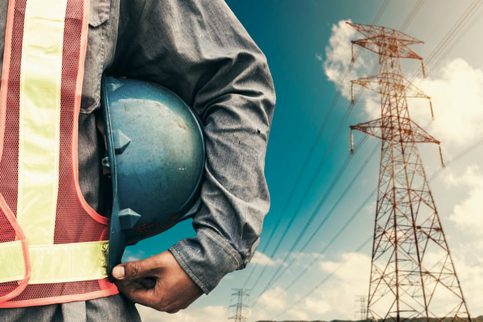 A man standing with power lines in background