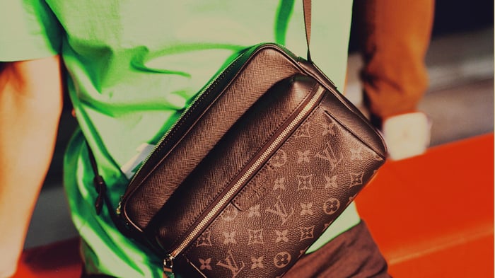 A men's Louis Vuitton messenger bag.