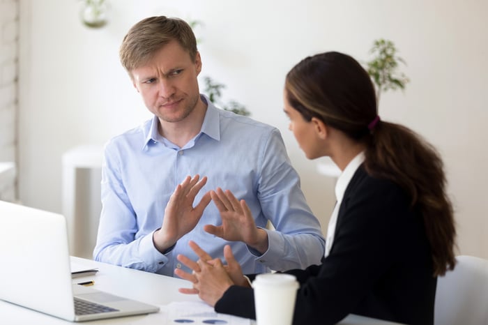 Man rejecting to discuss with business partner.