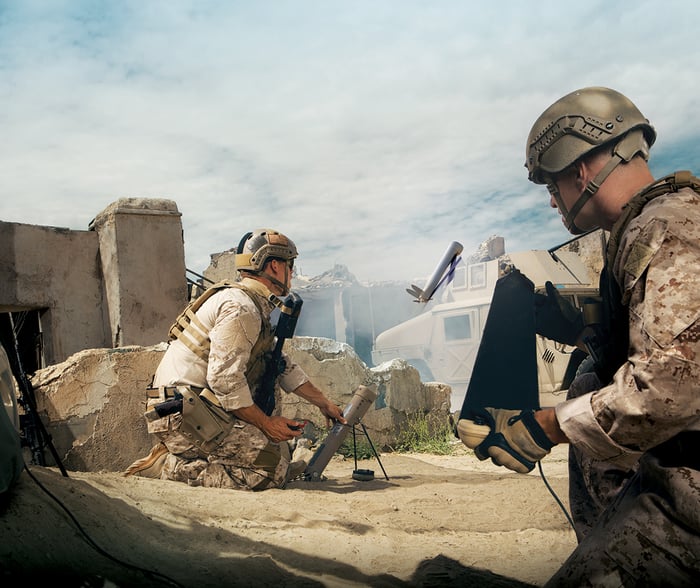 Soldier fires a Switchblade drone from a tube launcher.