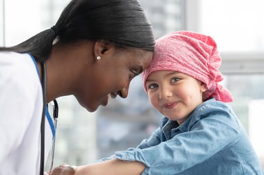 female healthcare provider and child oncology patient