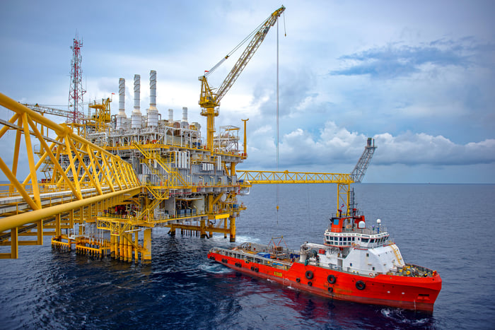 Large Offshore oil rig drilling platform at sunset and beautiful sky