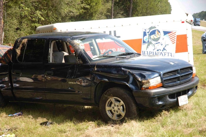 Photo of crashed truck and Uhaul trailer.