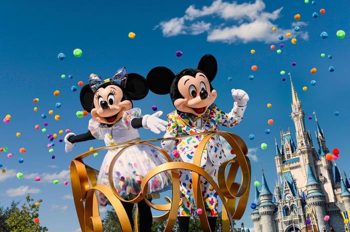 Mickey and Minnie on a float during a theme park parade.