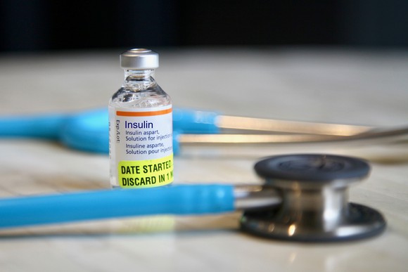 Vial of insulin with stethoscope.