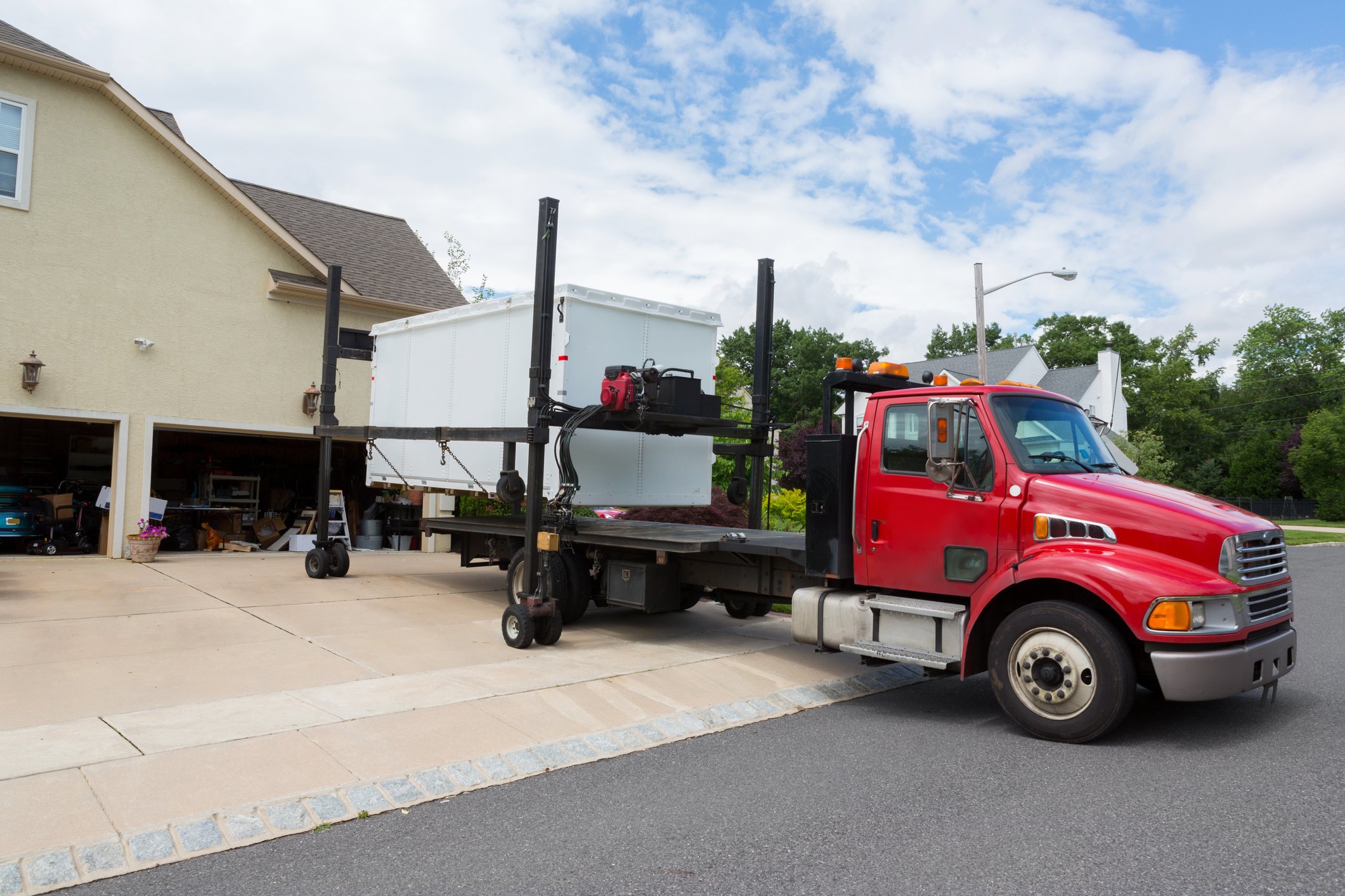 Portable storage container being delivered on a truckbed