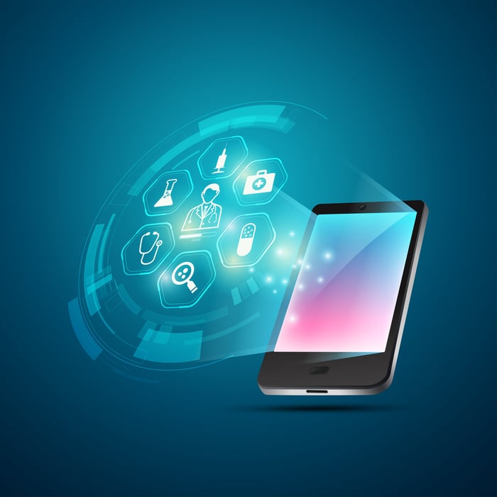 Tablet with medical symbols coming out