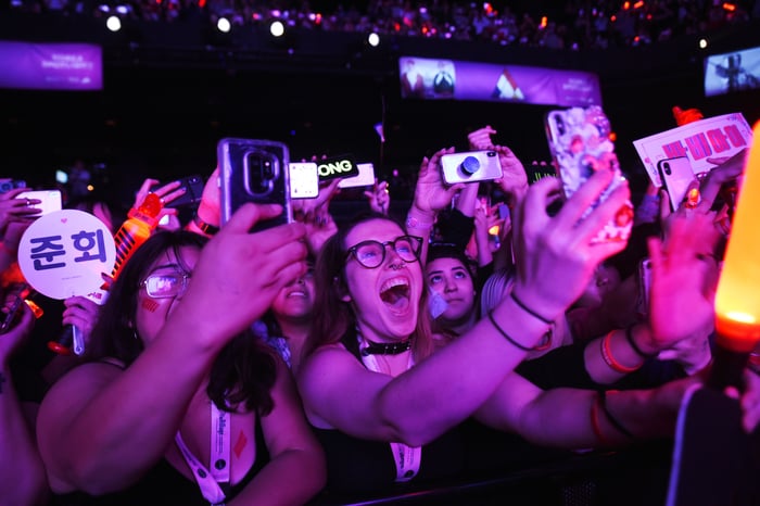 Crowds near a stage taking photos with phones at South by Southwest.