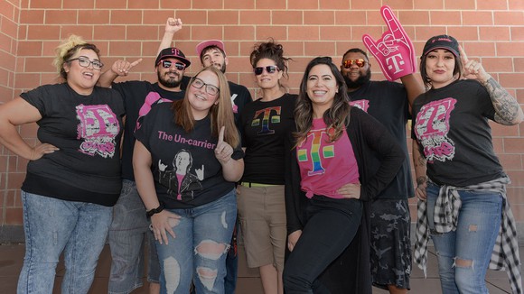 A group of young T-mobile employees in celebratory mode.