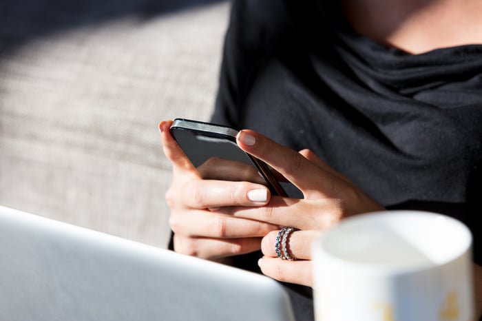 A woman looking at her smartphone