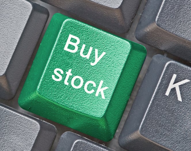 "Buy stock" on a green key surrounded by gray keys on a keyboard.