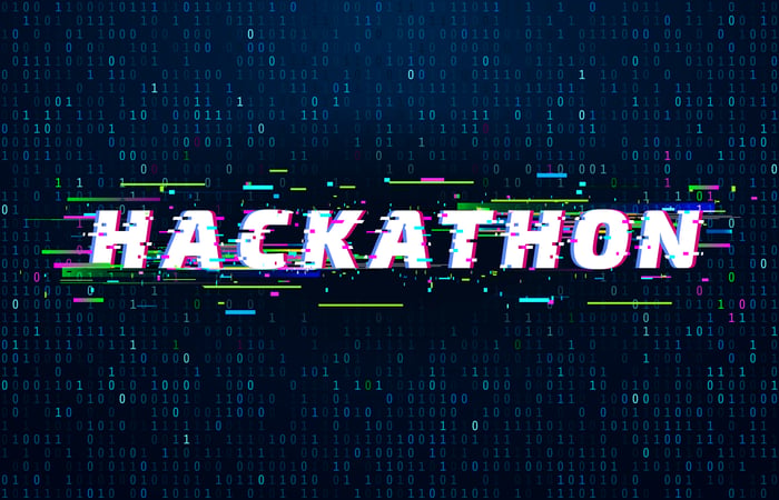 Hackathon sign behind computer code. 
