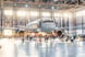 View inside the aviation hangar, the airplane aerospace mechanic working around the service getty