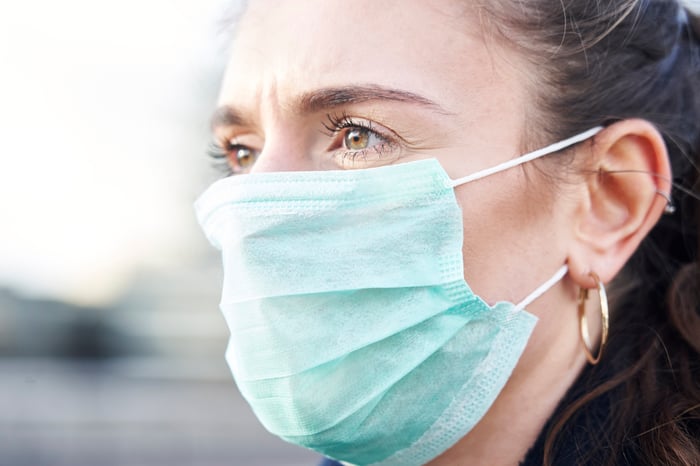 An up-close view of a woman wearing a face mask. 