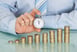 Stopwatch With Growing Stack of Coins Profit Investing Getty