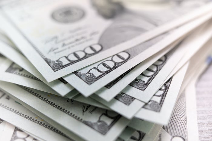 An up-close view of a messy stack of one-hundred-dollar bills.